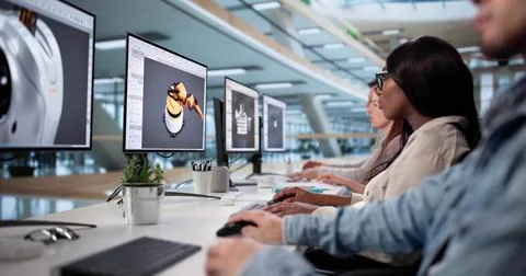 Diverse Team Of Designers Developing 3D CAD Models Online 库存照片