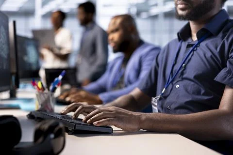 Diverse team of developers in data center identifying errors Stock Photos