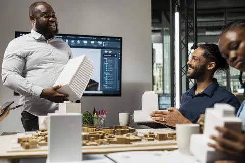 Diverse team of developers sharing construction details in a briefing session Stock Photos