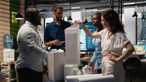 Diverse team of developers sharing construction details in a briefing session Stock Photos