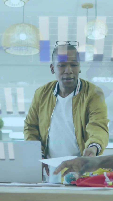 Diverse team discusses documents, animating statistical data in a business Stock Footage 321852919