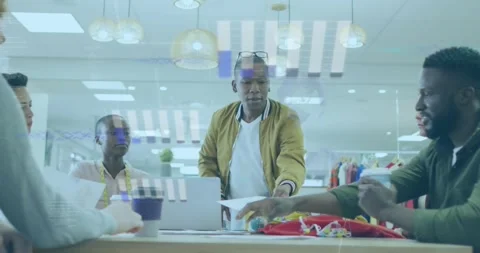 Diverse team discusses documents, animating statistical data in a business Stock Footage 328005260