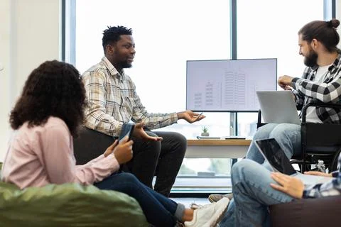 Diverse team discussing an architectural project in an inclusive workplace Stock Photos