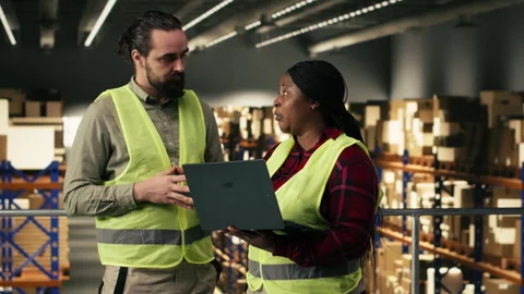 Diverse team of employees, laptop tracking software, logistics center Stock Footage 330377739