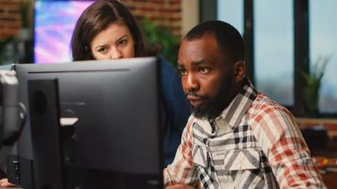 Diverse team of employees working on software development Stock Photos