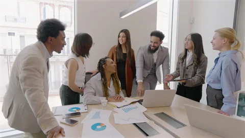 A Diverse Team Engaging in Collaboration Within a Modern and Innovative Office Stock Footage 305437390