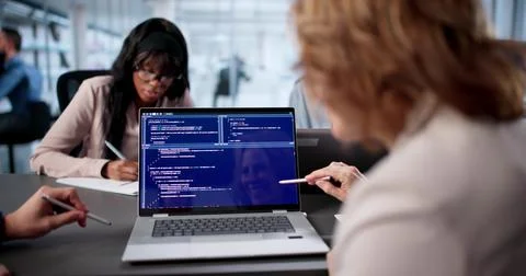 Diverse Team Of Engineers Collaboratively Code Software In Busy Office. Stock Photos