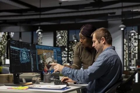 Diverse team of engineers using artificial intelligence to design a floor plan 写真素材