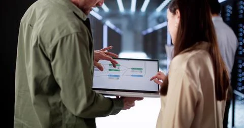 Diverse Team Of Engineers Using Node Editor Stock Photos