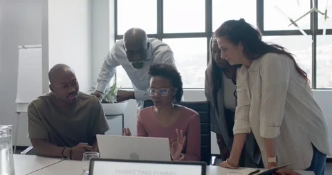 Diverse team gathering as presenter clicking laptop, reviewing marketing funnel Stock Footage 342284908