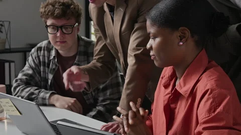 Diverse Team of IT Professionals Working on Laptop in Office Stock Footage 336710910