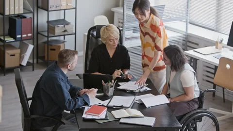Diverse Team of Managers Discussing Documents at Office Table Stock Footage 335760126