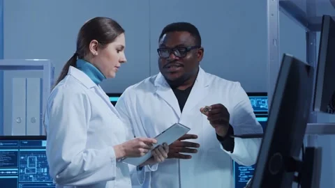 Diverse team of microelectronic engineers discuss current developments in a Stock Footage 149958406