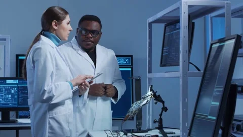 Diverse team of microelectronic engineers discuss current developments in a Stock Footage 150173277