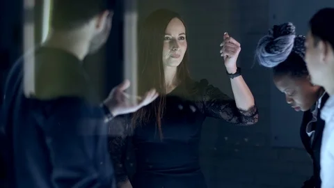 A diverse team of multinational businessmen is working late at night on a new Stock Footage 124942553