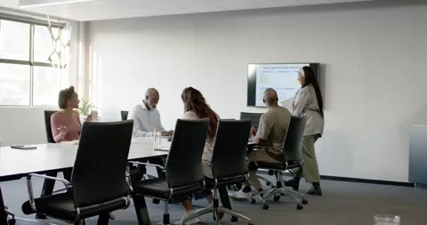 Diverse team in office shifting focus as presenter entering walking to screen Stock Footage 342284778
