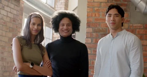 Diverse team posing for portrait in loft office as camera moving, smiling, Stock Footage 339961374