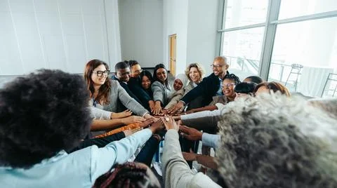 Diverse team of professionals collaborating together and solving problems i.. Stock Photos