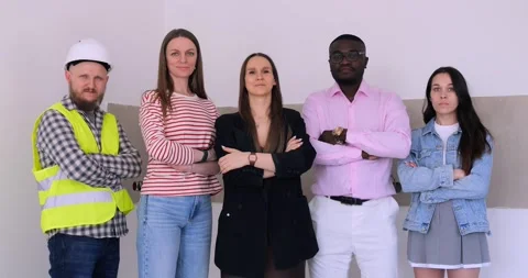 Diverse team of professionals demonstrates teamwork in renovation. Teamwork Stock Footage 274825452