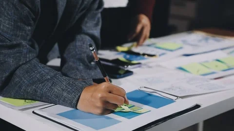 Diverse team of professionals engaged in a website graphic design board mee.. Stock Footage 317429399