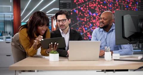 Diverse Team Of Professionals Using Laptops And Tablets For Data Analysis. Pe Stock Photos