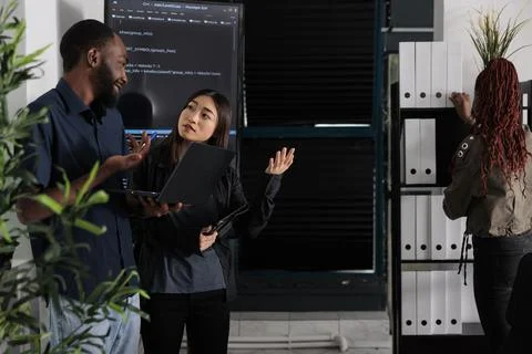 Diverse team of programmer analyzing html code on laptop Stock Photos