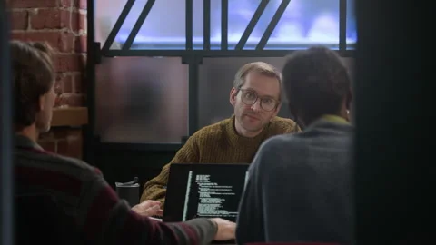 Diverse Team of Programmers Brainstorming Ideas for IT Startup in Office Stock-Footage 319999631