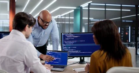 Diverse Team Of Programmers Coding Software Together During Office Meeting. Y Stock Photos