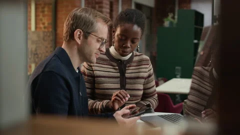 Diverse Team of Programmers Discussing Software on Tablet Computer Stock Footage 319998070