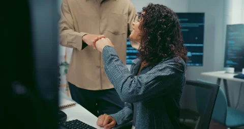 Diverse team programmers give fist bump to celebrate success at office. Stock Footage 344033287
