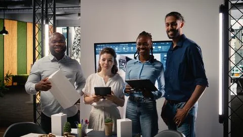Diverse team of real estate developers using 3D models in a modern office Stock Photos