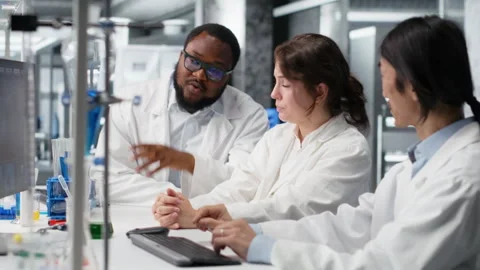 Diverse team of research facility professional using PC software Stock Footage 320726006
