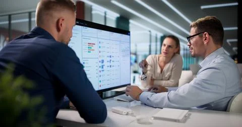 Diverse Team Reviews Cloud-based Invoices During Financial Data Analysis. Stock Photos