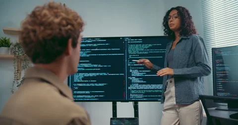 Diverse team software developer present coding on screen to colleague. Stock Footage 343947923