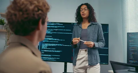 Diverse team software developer present coding on screen to colleague. Stock Footage 343947928
