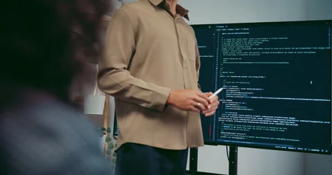 Diverse team software developer present coding on screen to colleague. Stock Footage 343947986