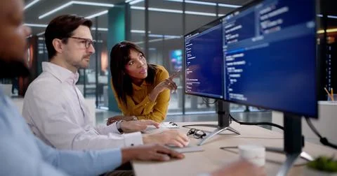 Diverse Team Of Software Developers Coding, Collaborating, And Leading Projec Stock Photos