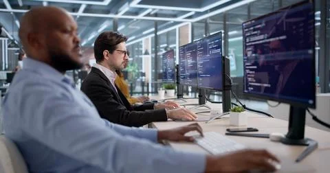 Diverse Team Of Software Engineers Coding Security Programs In An Office. Peo Stock Photos