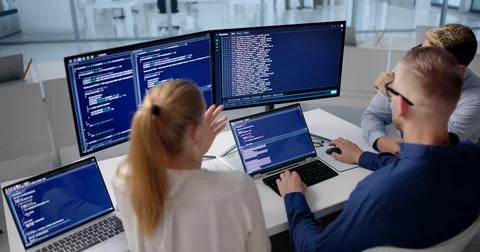 Diverse Team Of Software Engineers Coding Secure Web Applications Together. Foto stock