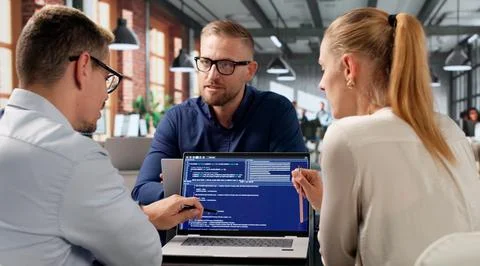 Diverse Team Of Software Engineers Coding Secure Web Applications Together. Fotos Stock