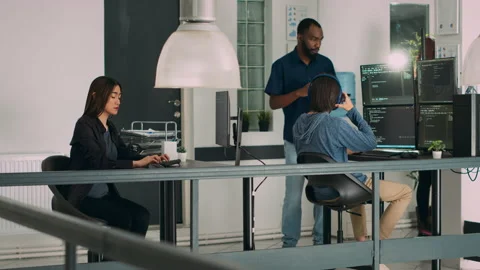 Diverse team of software engineers writing server code on terminal window Stock Footage 224453892