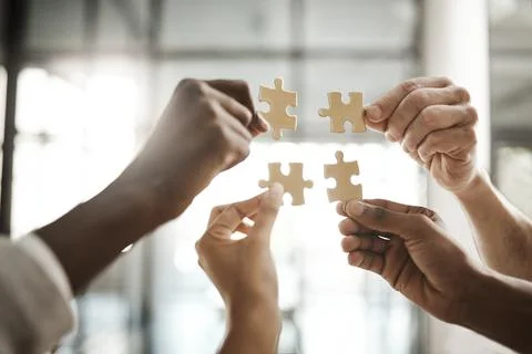 Diverse team solving a problem together due to teamwork, support and helping Stock Photos