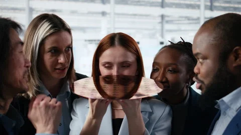 Diverse team of technicians examine semiconductor substrate in research office Stock Footage 335880732