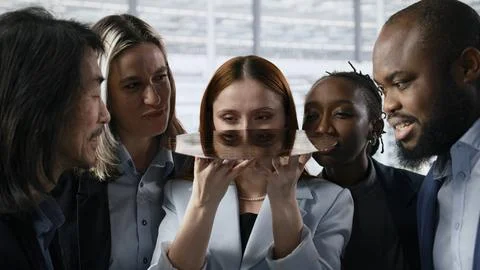 Diverse team of technicians examine semiconductor substrate in research office Stock Photos