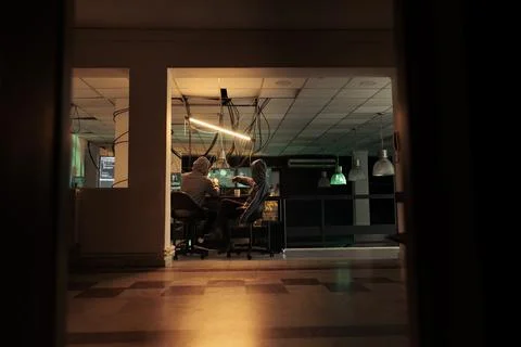 Diverse team of thieves coding trojan virus late at night Foto stock