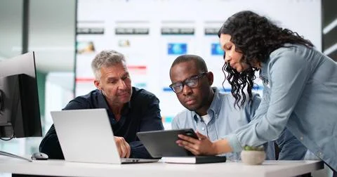 Diverse Team Of UI Designers Collaborating On Mobile App UX. Stock Photos