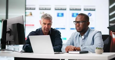 Diverse Team Of UI Designers Creating Mobile App UX Designs. Stock Photos