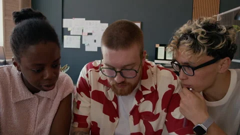 Diverse Team of UI Designers Testing Mobile App on Phone Working at Office Stock Footage 313933825