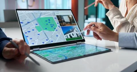Diverse Team Uses A Digital Map To Plan Real Estate Investment. Stock Photos
