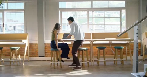 Diverse team walking in loft, high-fiving, leaning, opening laptop and Stock Footage 337944585